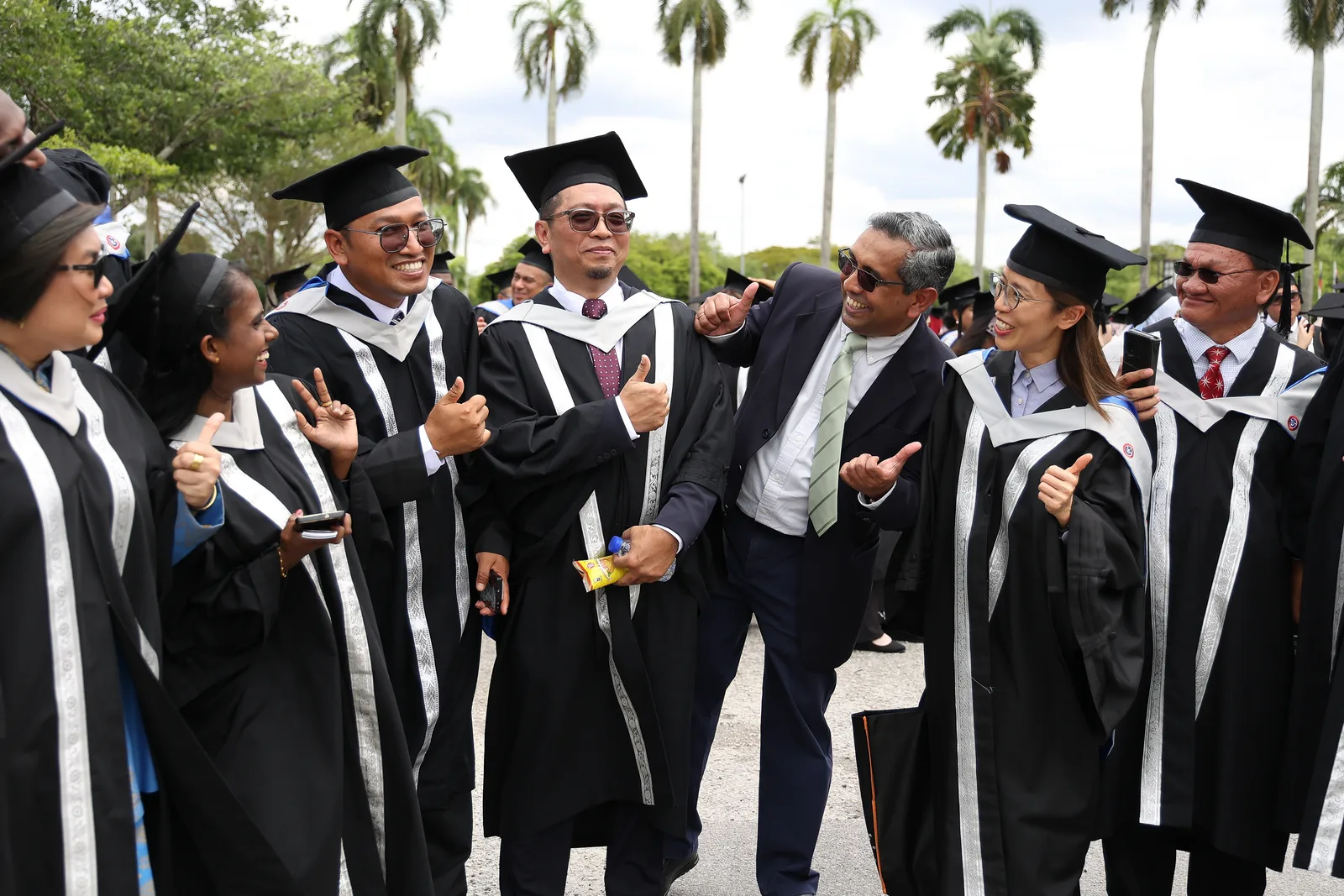KTAC graduates and educators posing together outdoors