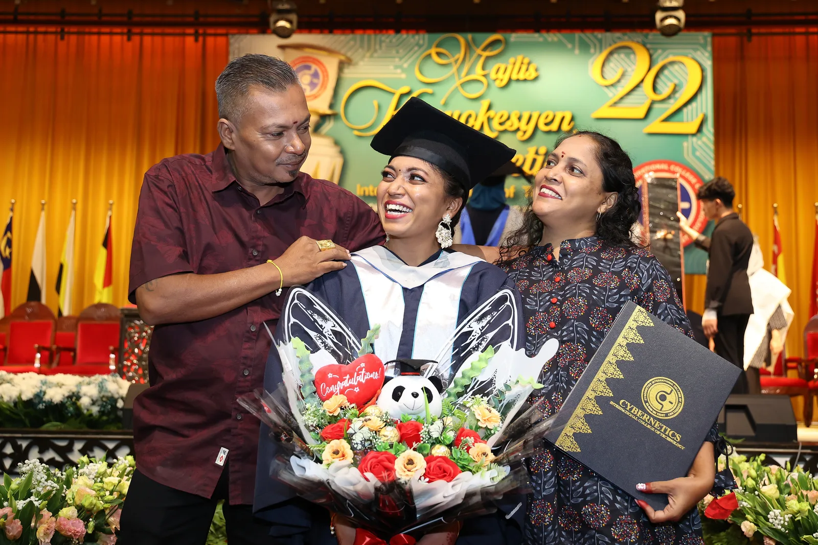KTAC graduate posing with family after convocation