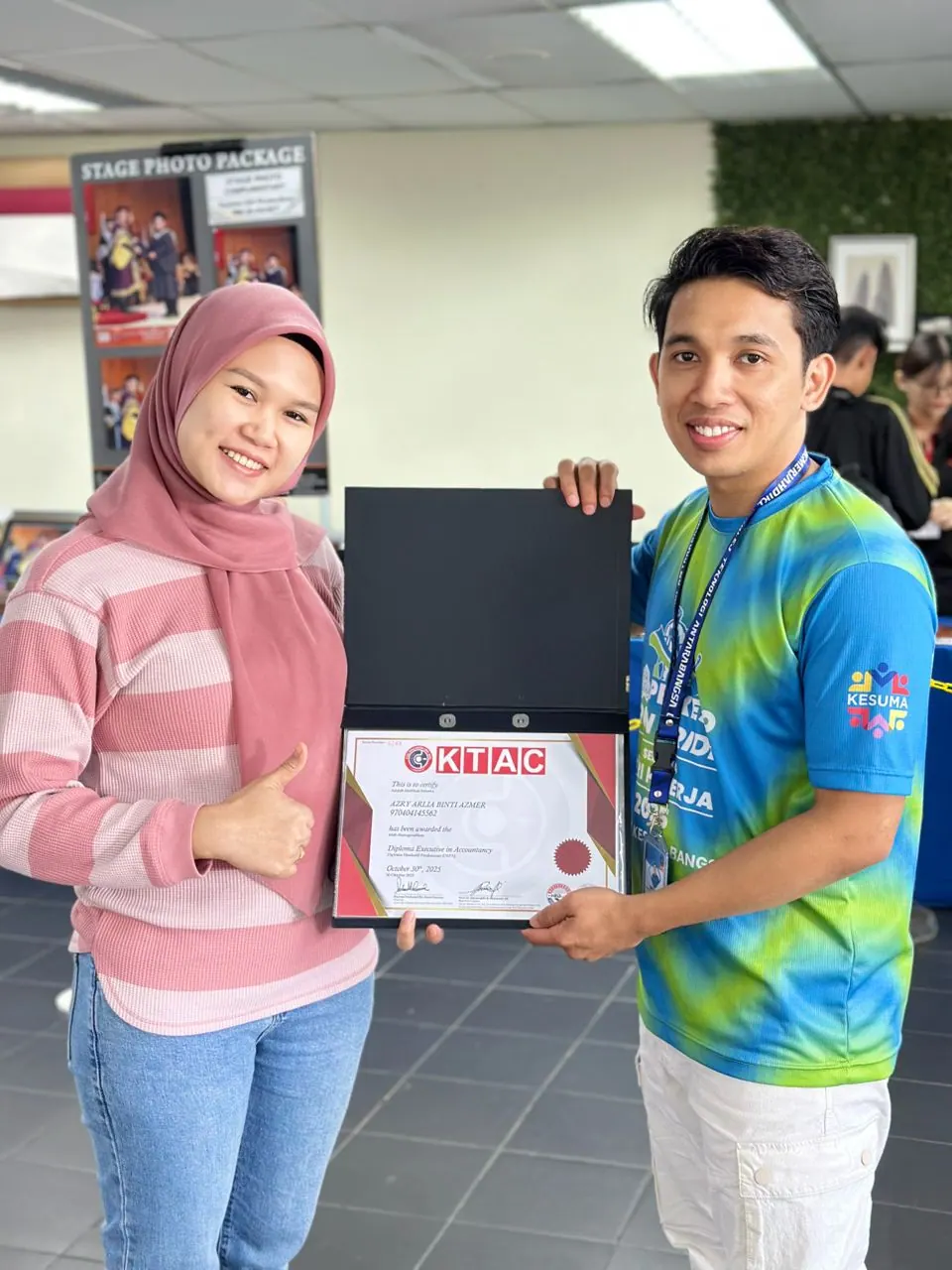 KTAC student receiving a certificate with a KTAC representative
