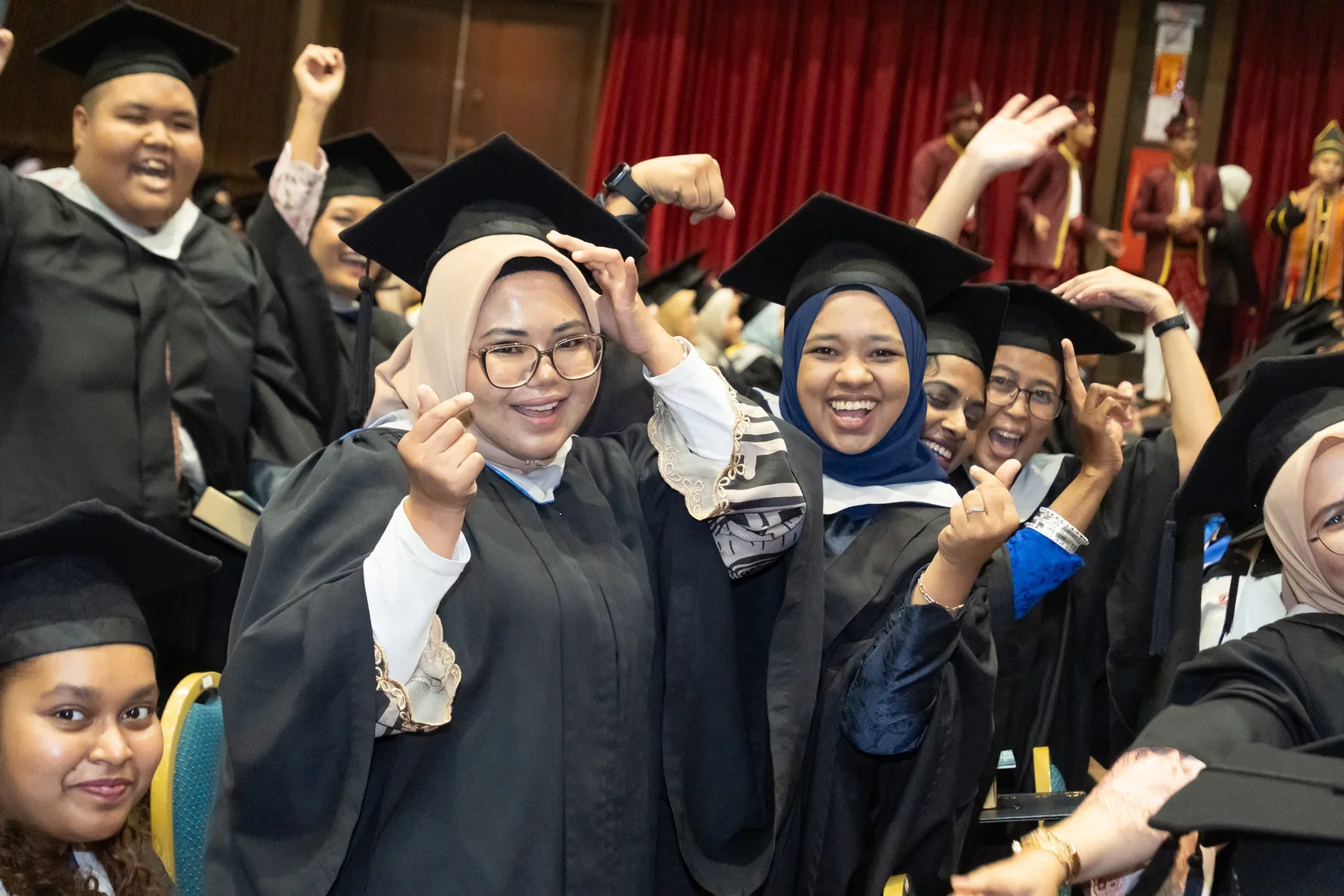 KTAC graduates smiling and celebrating with friends