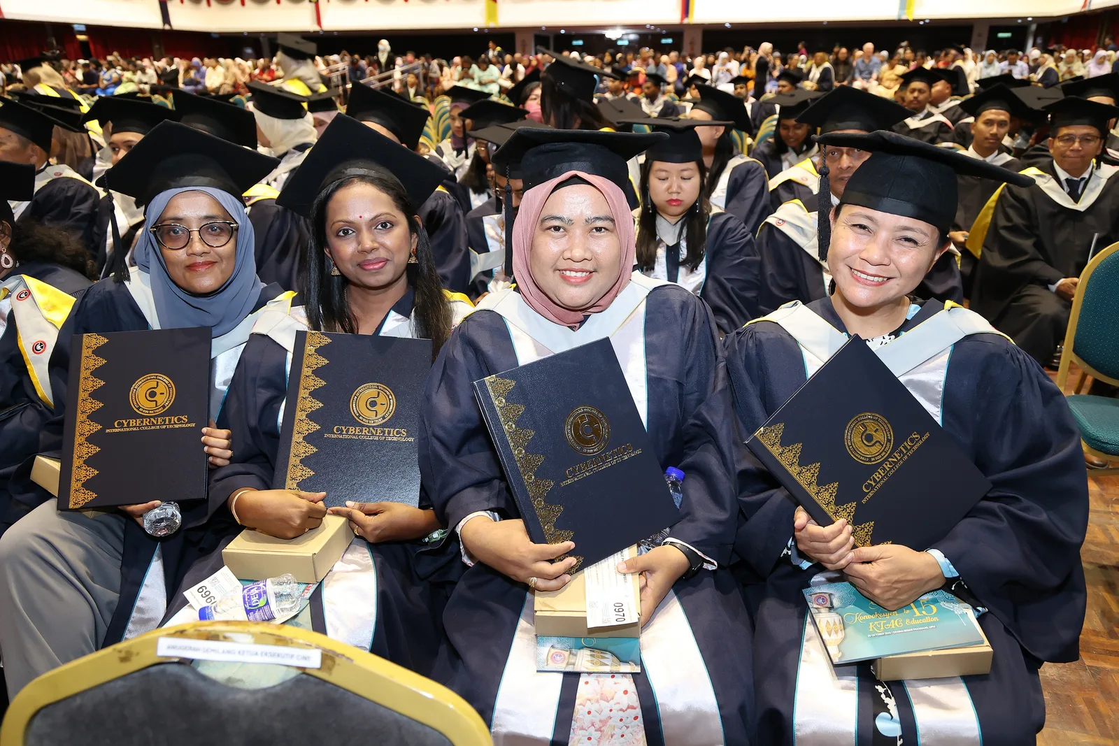 KTAC woman graduate holding a certificate folder during convocation